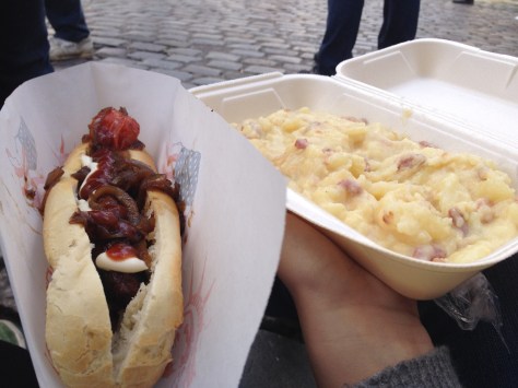 A sausage in a French baguette topped with caramelized onions and ketchup and mayo. Then that mashed potato thing. 